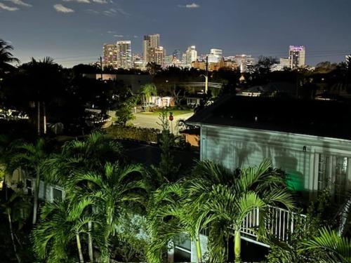 a view of a city with palm trees and a building at Victoria Park Overlook in Fort Lauderdale