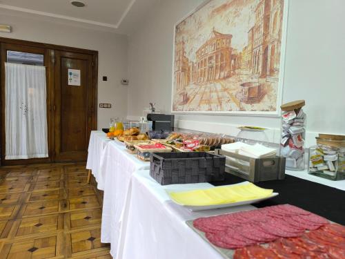 a row of white tables with food on them at Hotel Santa Barbara in Andorra