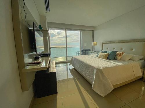 a bedroom with a bed and a view of the ocean at hyatt(H2)luxury in Cartagena de Indias