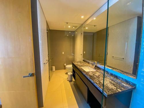 a bathroom with a sink and a toilet and a mirror at hyatt(H2)luxury in Cartagena de Indias