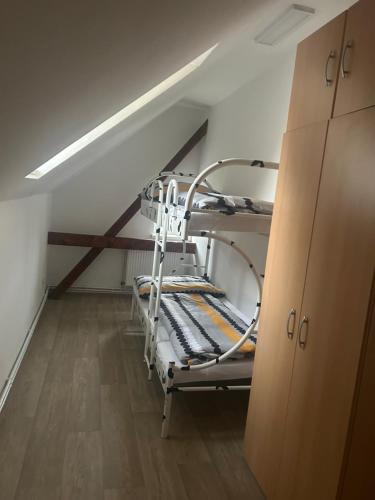 a room with a bunk bed in a attic at Apartmán Krkovička in Mikulášovice