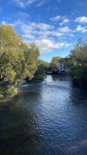a river with a building on the side of it at Le 40 in Sarreguemines