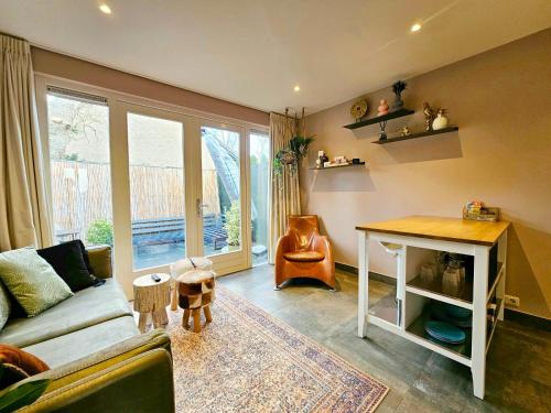 a living room with a couch and a table at Zandvoort at Home I Free parking & Airco in Zandvoort