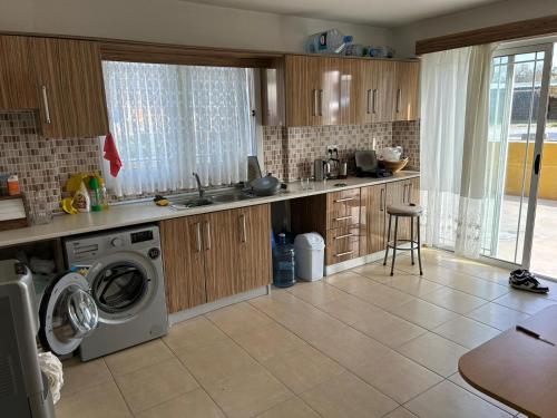 a kitchen with a sink and a washing machine at Özel Mülk in Famagusta