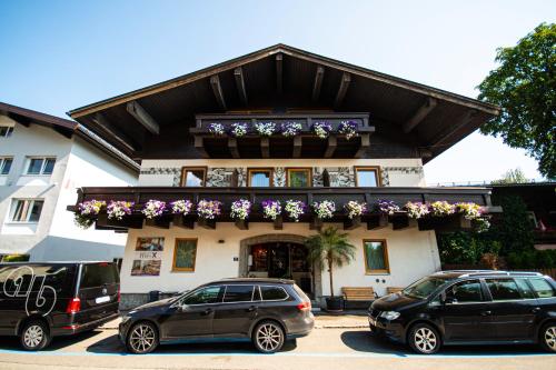 two cars parked in front of a building at Pension Max in Zell am See