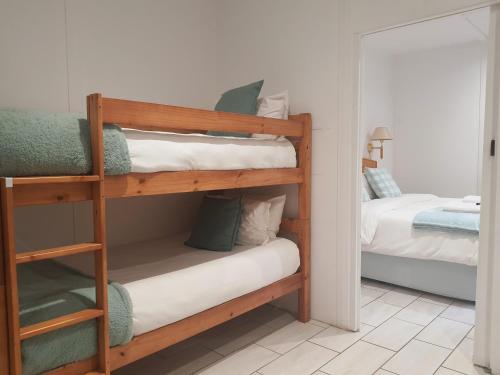 a room with two bunk beds and a mirror at Rhino Manor in Vanderkloof