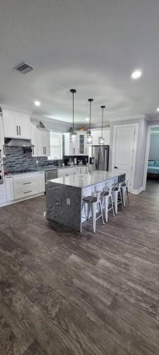 a large kitchen with a large island in the middle at Villa White Rock in Tampa in Tampa