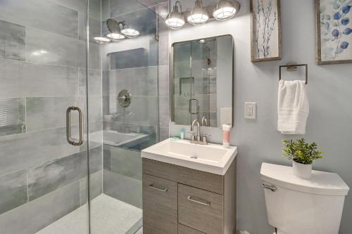 a bathroom with a shower and a sink and a toilet at Bayfront Maryland Retreat with Deck, Near Beaches! in North Beach