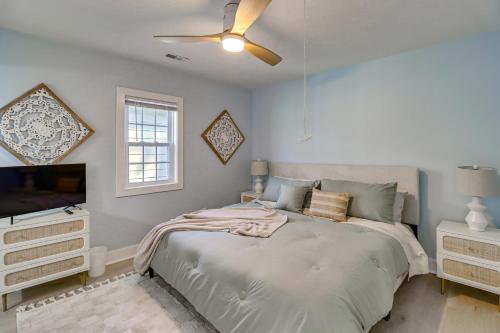 a bedroom with a bed and a flat screen tv at Bayfront Maryland Retreat with Deck, Near Beaches! in North Beach