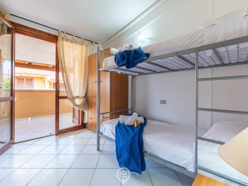 a bedroom with two bunk beds and a balcony at Villasimius Coastal Nest in Villasimius