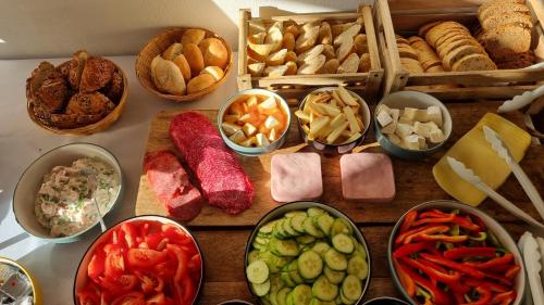 a table topped with different types of food in bowls at Fatrapark 2 Apartments HRABOVO - Hlavná recepcia in Ružomberok