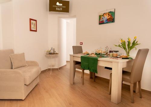 a dining room with a table and a couch at Domus Cuomo B&B in Nocera Inferiore