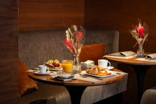 a table with breakfast foods and drinks on it at Cerretani Hotel Firenze - MGallery Collection in Florence