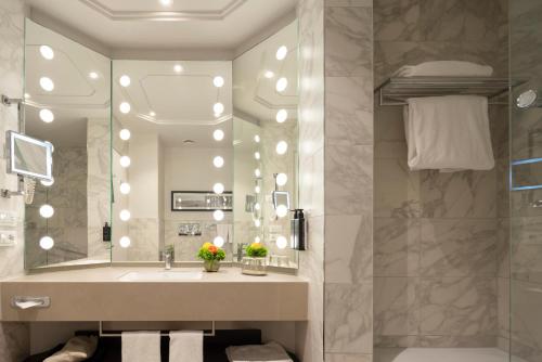 a bathroom with a sink and a mirror at Cerretani Hotel Firenze - MGallery Collection in Florence