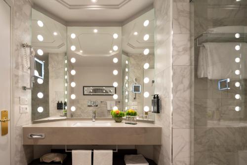 a bathroom with a sink and a mirror at Cerretani Hotel Firenze - MGallery Collection in Florence