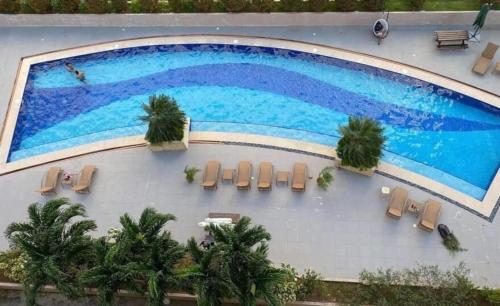 an overhead view of a swimming pool with chairs and trees at Saekyung Village One-Phase 2 in Lapu Lapu City