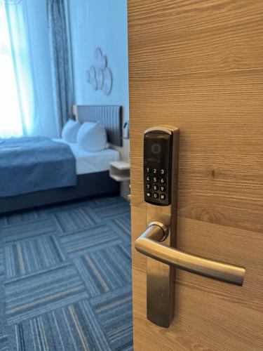 a door with a door handle with a bedroom at Hotel Bregenz in Berlin