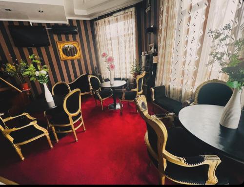 a room with chairs and a table and a red carpet at Hotel Zava Boutique Central in Bucharest