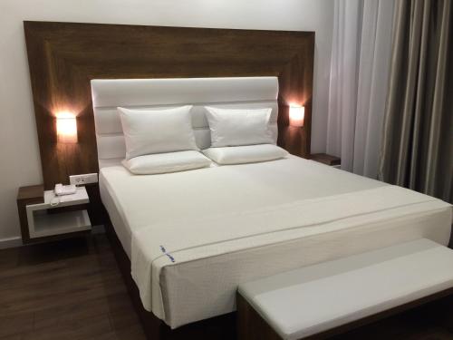 a bedroom with a large bed with white sheets and pillows at Perla Luxury in Ulcinj