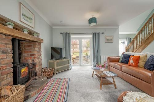 a living room with a couch and a fireplace at No7 Drummond Street, 2 bedrooms, Comrie in Comrie