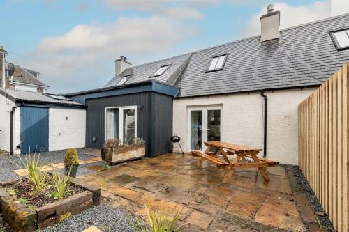 a house with a wooden picnic table in front of it at No7 Drummond Street, 2 bedrooms, Comrie in Comrie