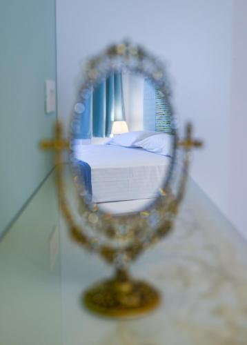 a mirror in a room with a bed in it at Koskinou Traditional Houses in Koskinou