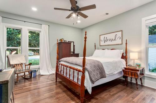 a bedroom with a bed and a ceiling fan at The Grove Cottage - Downtown Springdale in Springdale