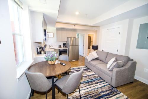 a living room with a couch and a table at The Vianny:Petite Modern Lodge in Washington, D.C.