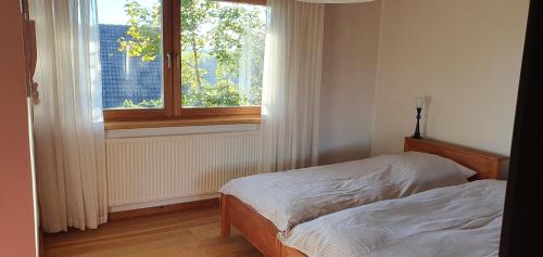 En eller flere senge i et værelse på Außergewöhnliches Ferienhaus im Schwarzwald