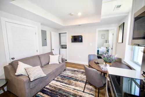 a living room with a couch and a table at The Vianny:Petite Modern Lodge in Washington, D.C.