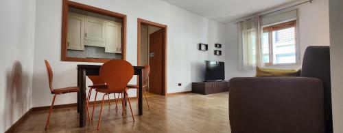 a living room with a table and chairs and a couch at Rotolo Suite 502 in Catania