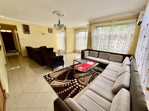 a living room with a couch and a table at Burka Serene Home in Arusha
