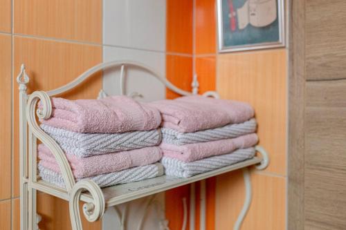 a pile of towels on a towel rack in a bathroom at Apartments Kot'č in Kranjska Gora