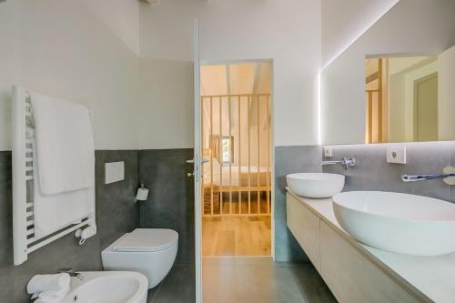 a bathroom with a white sink and a toilet at Le Stanze del Lago Villa Seta in Como