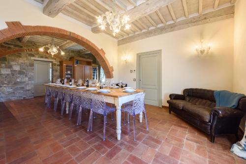 a large dining room with a table and a couch at Villa Conca d'Oro by Mmega in Greve in Chianti