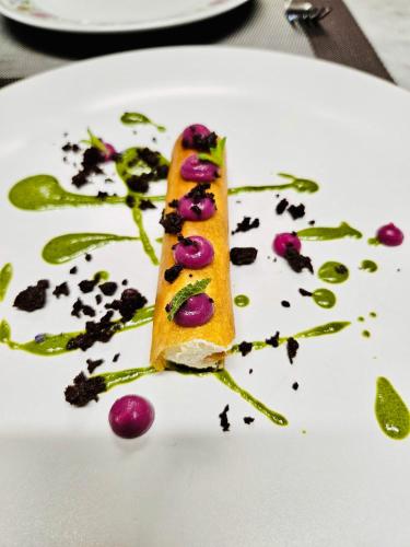 a piece of food on a white plate at LaChiusa Tuscany in Montefollonico