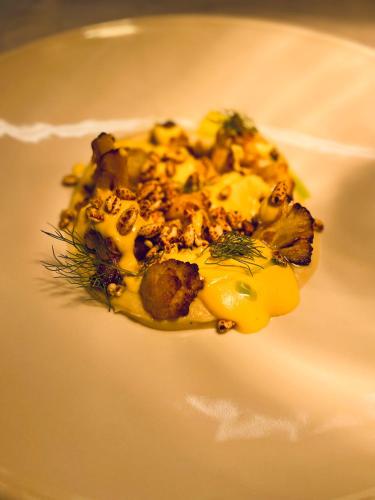 a piece of food on a white plate at LaChiusa Tuscany in Montefollonico