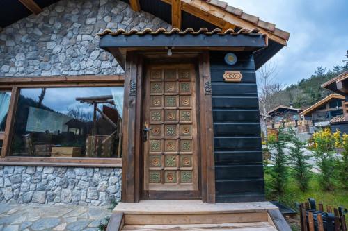 a wooden door on the side of a house at Bİ ABANT MASALI VİLLAGE HOTEL in Arkaoğluköyü