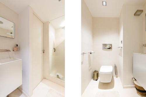 a white bathroom with a toilet and a sink at 67 Croisette YourHostHelper in Cannes