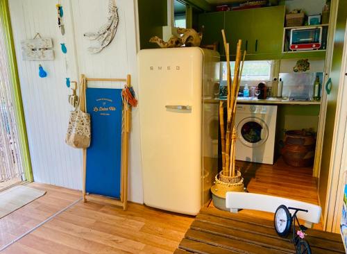 a kitchen with a white refrigerator in a room at Casa di Babbo …la Cabane in Sorbo-Ocagnano