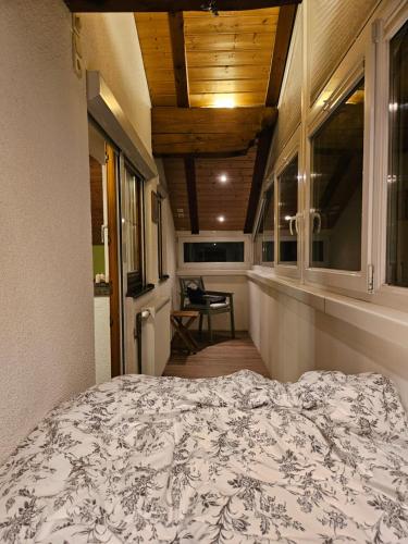 a bedroom with a bed and a hallway with a chair at Privatzimmeroase Felicitas exklusive Zimmer in Zirl