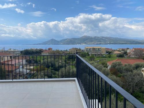 a balcony with a view of the water at DION APARTMENTS in Paleros