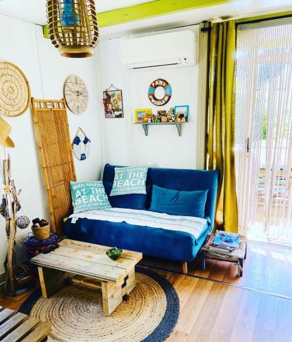 a blue couch in a living room with a coffee table at Casa di Babbo …la Cabane in Sorbo-Ocagnano