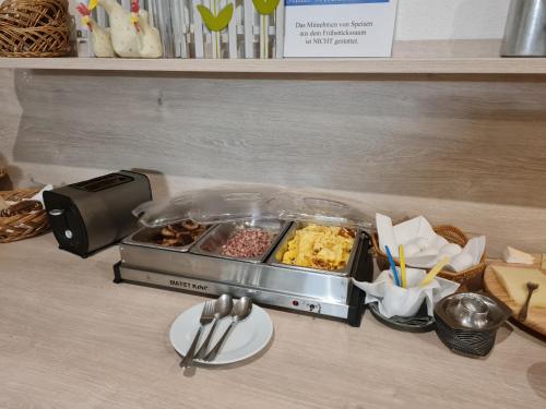 a counter top with a buffet of food on a table at Hotel Stadt Witzenhausen in Witzenhausen
