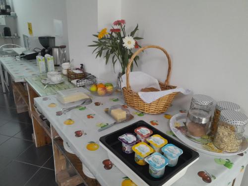 a table in a kitchen with food on it at Change The World Hostels - Açores - Ponta Delgada in Ponta Delgada