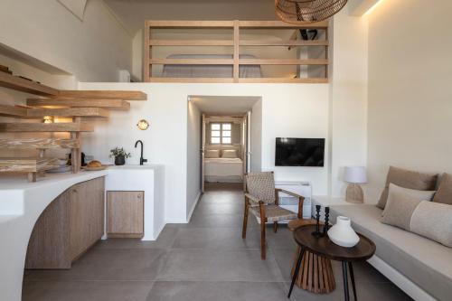 a living room with a couch and a table at Frescoes Luxury Suites By KB Hospitality in Mesaria