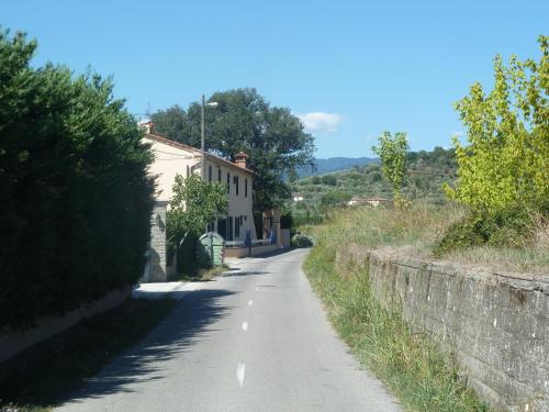 an empty road next to a stone wall at Al Vecchio Leccio in Pistoia
