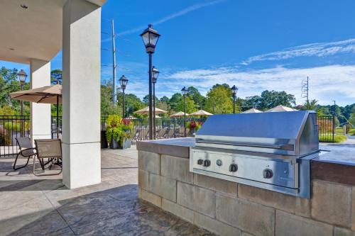 a grill on a stone wall in a patio at Residence Inn by Marriott Jackson The District at Eastover in Jackson