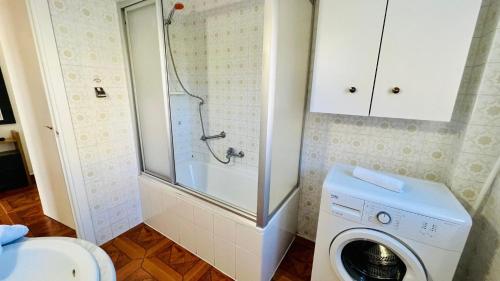 a bathroom with a washing machine and a shower at Apartamento Faro Torrox by At Home costa del Sol in Torrox