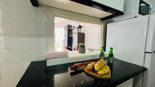 a kitchen with a table with a plate of food and two bottles at Apartamento Faro Torrox by At Home costa del Sol in Torrox